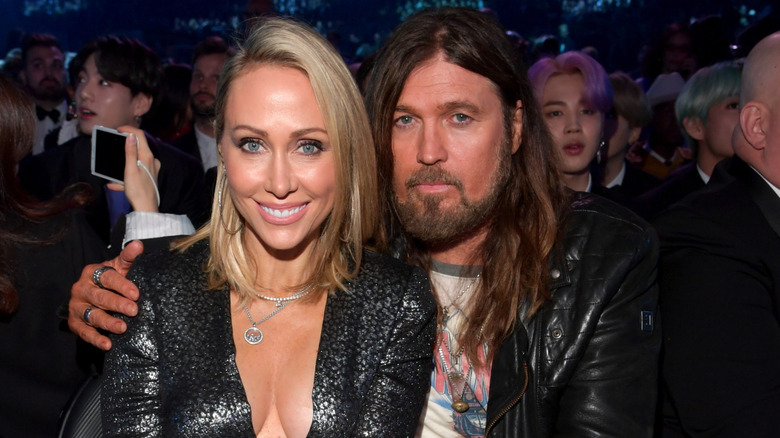 Billy Ray Cyrus and Tish Cyrus smiling for photos