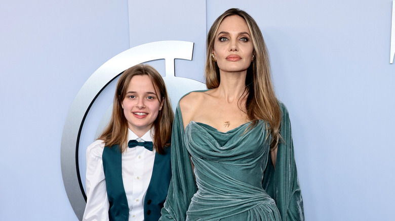 Vivienne Jolie-Pitt smiling with Angelina Jolie on red carpet