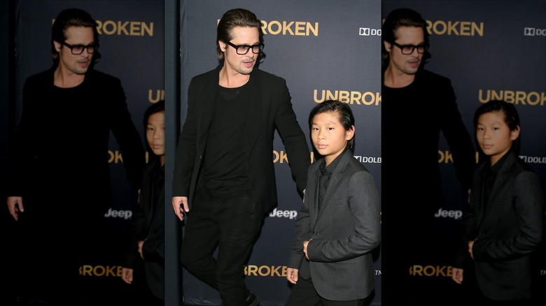 Brad Pitt stands next to his son, Pax Jolie-Pitt, at a premiere