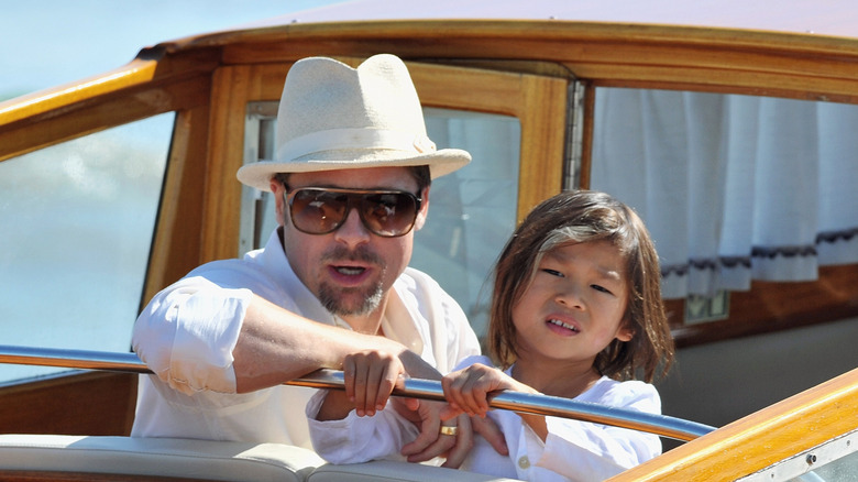 Brad Pitt and son Pax Jolie-Pitt ride on a boat