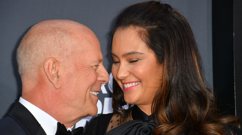 Bruce Willis and Emma Heming Willis smiling at each other at the 2018 Comedy Central Roast of Bruce Willis