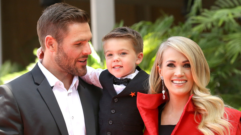 Mike Fisher, Isaiah Fisher, and Carrie Underwood smiling