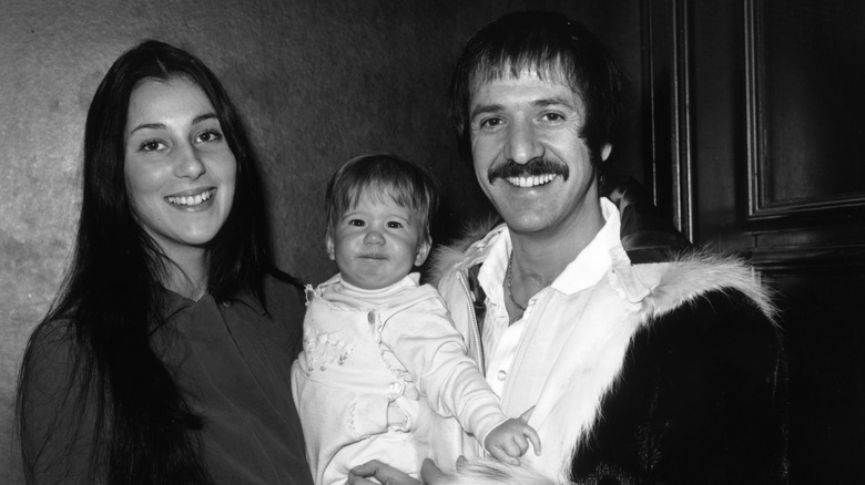 Sonny Bono and Cher holding baby Chaz