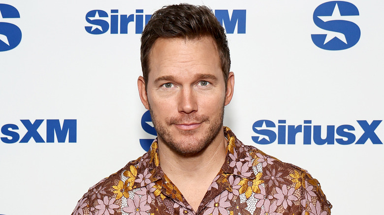 Chris Pratt posing for photos in a patterned shirt