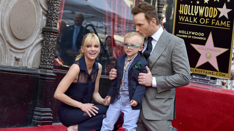 Chris Pratt kissing his son's head while Anna Faris smiles