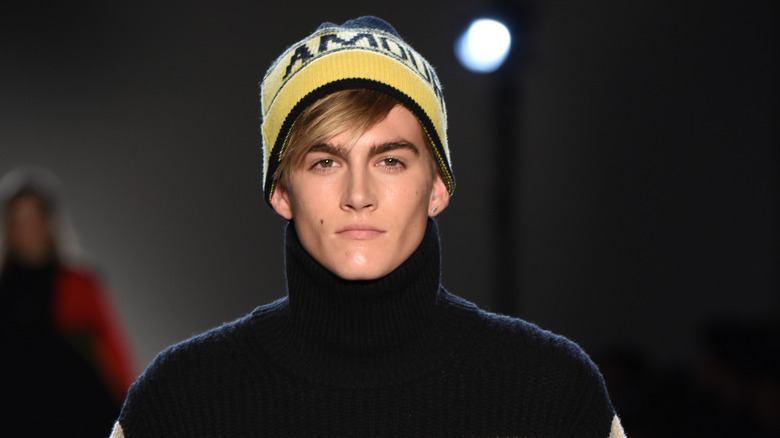 Presley Gerber wearing hat and walking runway