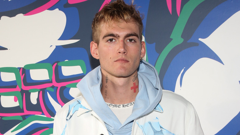 Presley Gerber posing in front of a colorful wall