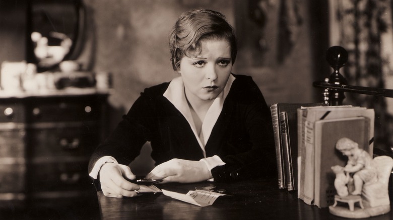 Clara Bow sitting at a desk 