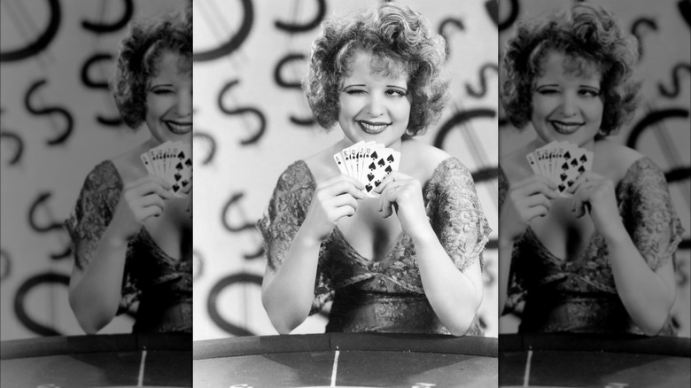 Clara Bow winking and showing she has a royal flush