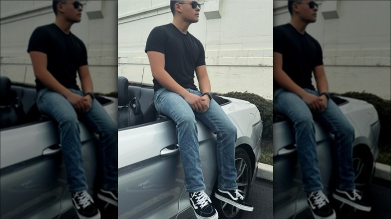 Collin Gosselin sitting on car