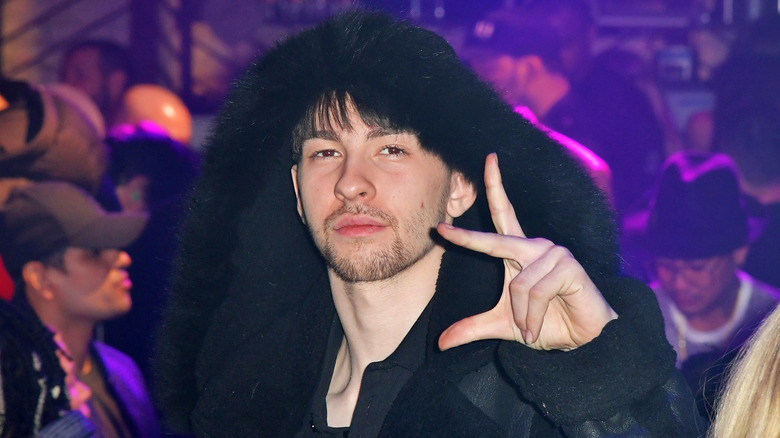 Declyn Lauper in fur hat and leather coat with two female friends