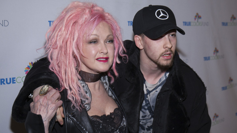 Cyndi Lauper with pink hair and Declyn Lauper in black ball cap and jacket