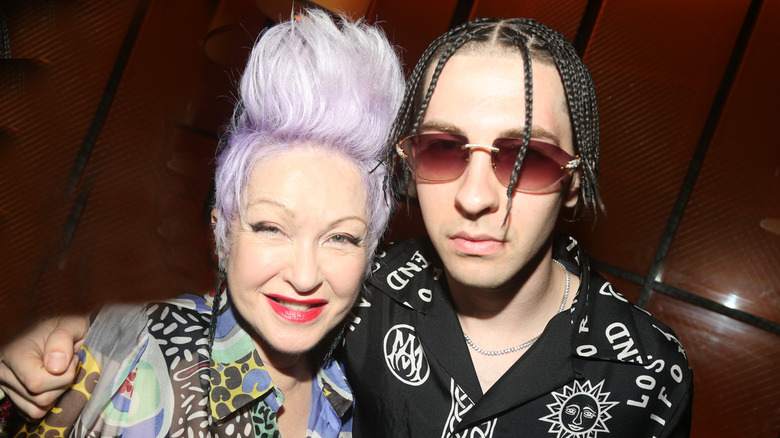 Cyndu Lauper with purple hair and Declyn Lauper in sunglasses with braids