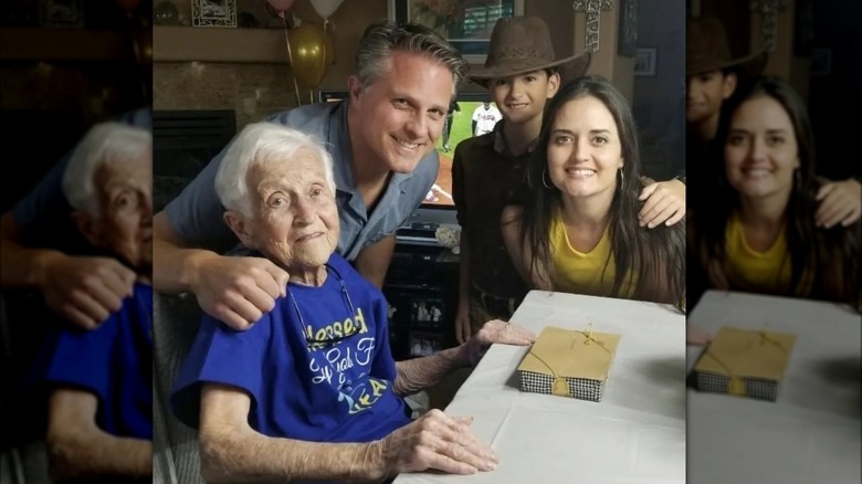 Danica smiling with her grandma Elsie, Scott Sveslosky, and son, Draco