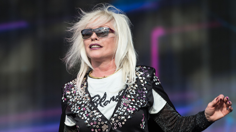 Debbie Harry in sunglasses and Blondie T-shirt with vest