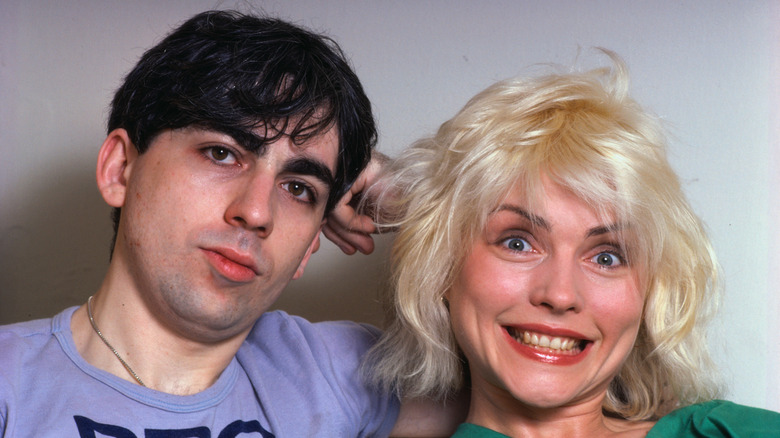 Debbie Harry in green shirt with Chris Stein in gray tee shirt