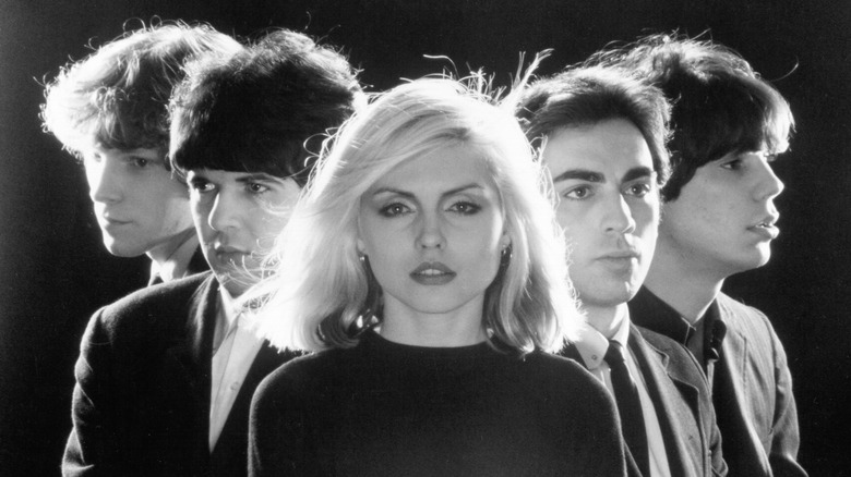 Black and white Blondie band photo with Debbie Harry in front and Chris Stein to her right.