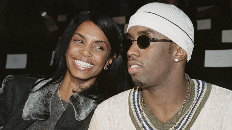 Kim Porter smiling next to Diddy