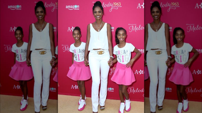 Kim Porter posing with Jessie and D'Lila Combs