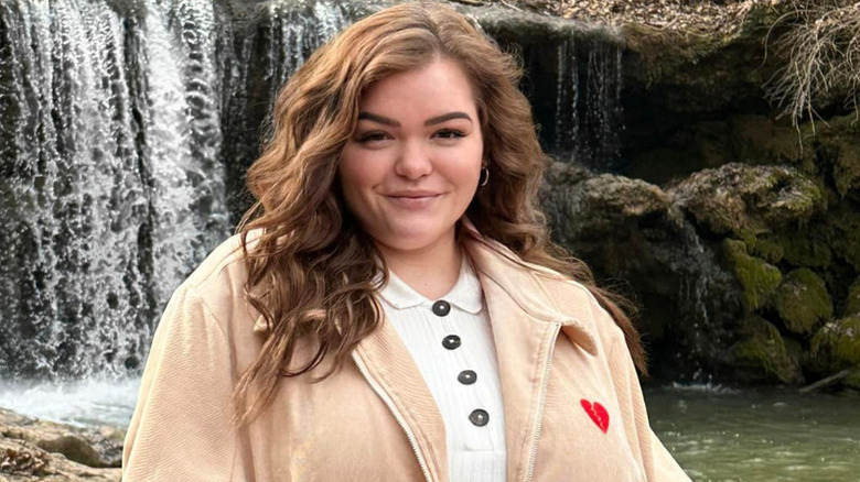 Bonnie Chapman smiling in front of a waterfall in February 2023