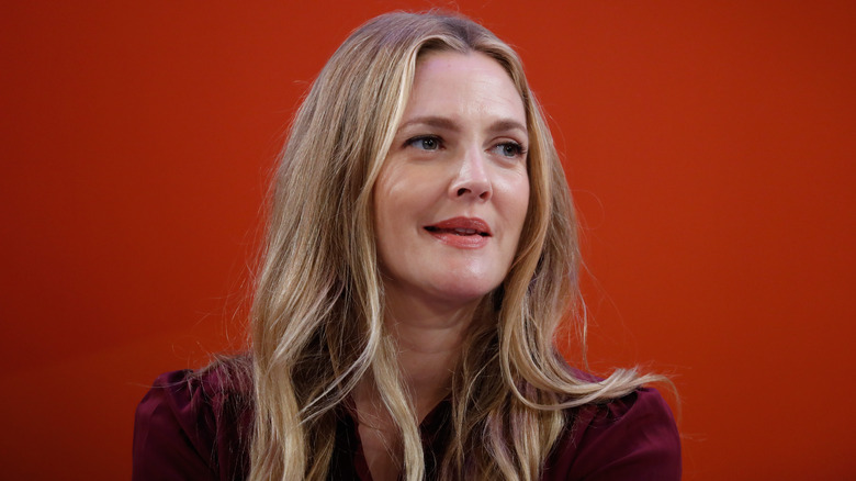 Drew Barrymore against red backdrop