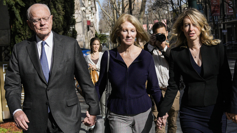 Elizabeth Holmes walking with her parents