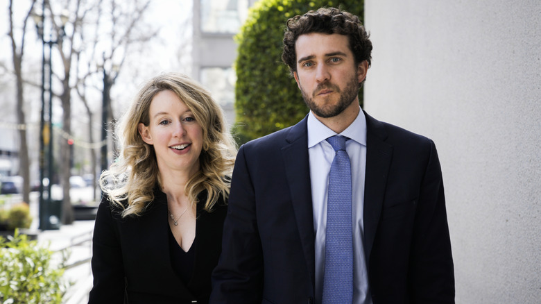 Elizabeth Holmes walking alongside her boyfriend Billy Evans