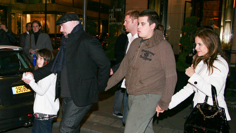 Ella Bleu Travolta, John Travolta, Jett Travolta, and Kelly Preston walking hand in hand