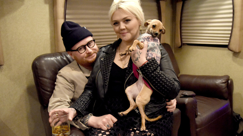 Fergie and Elle King holding a dog 