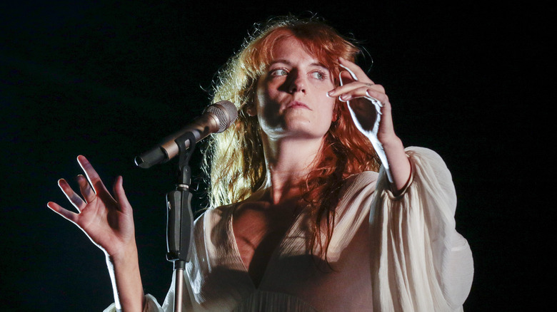 Florence Welch with hands up