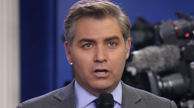 Jim Acosta speaking into a microphone