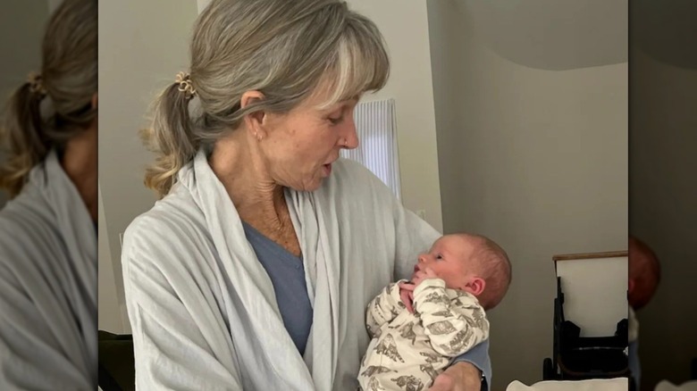 Karen E. Laine holding a baby