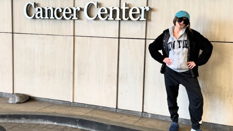 Kat Timpf standing by cancer center sign