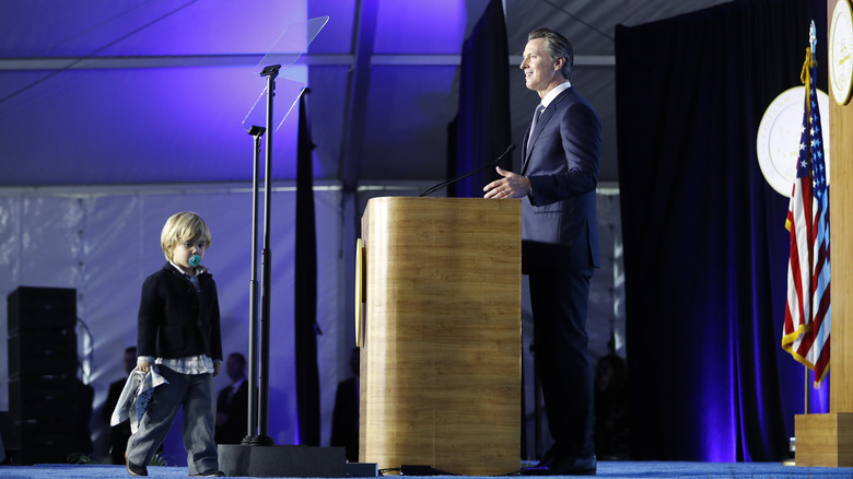 Gavin Newsom making speech with son on stage