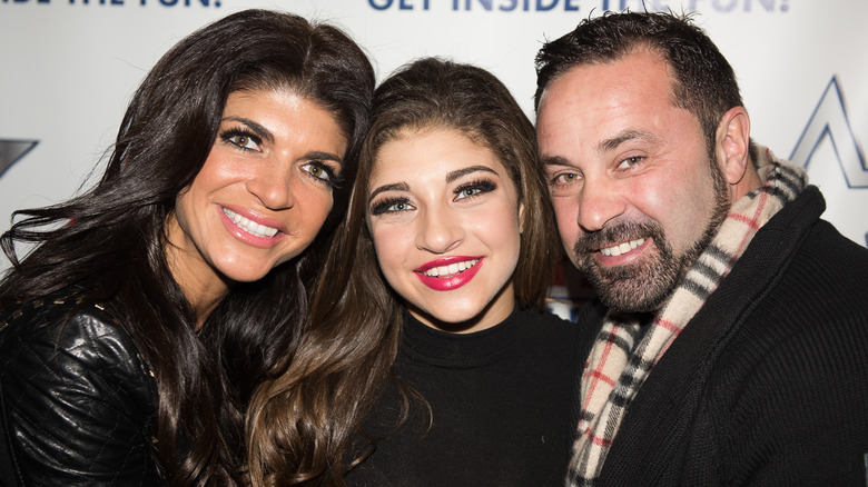 Gia Giudice smiling with parents