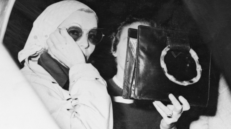 Greta Garbo hiding from paparazzi  