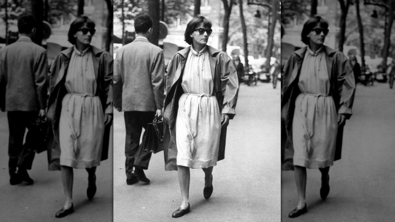 Older Greta Garbo walking on street