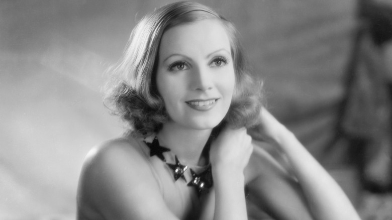 Greta Garbo smiling and posing