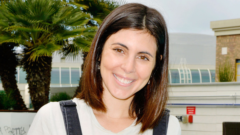 Jamie-Lynn Sigler posing in overalls