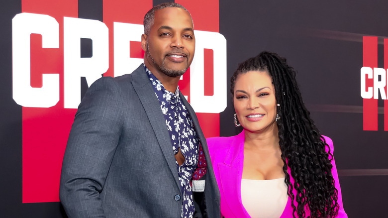 HGTV stars and couple Mike Jackson & Egypt Sherrod smile standing side by side