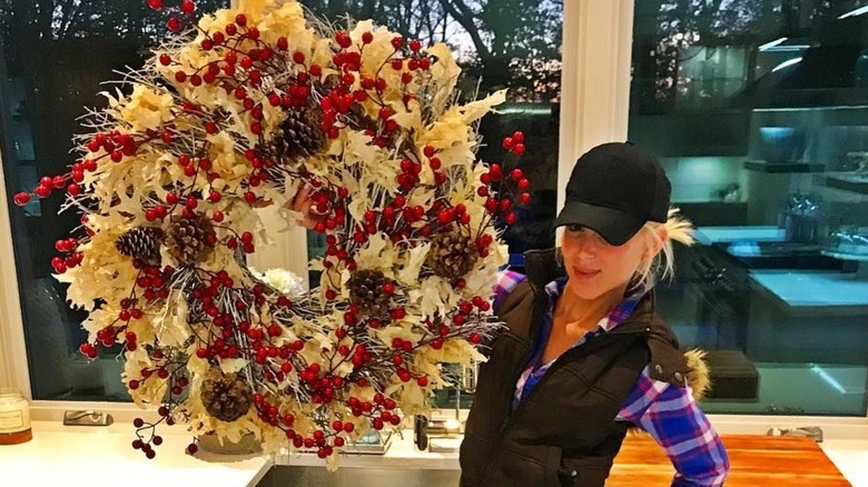 Galey Alix smiling, holding wreath