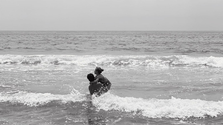 Nate Berkus in the ocean with his daughter