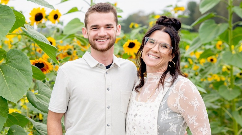 Miles Lamb and Lyndsay Lamb standing in a sunflower field