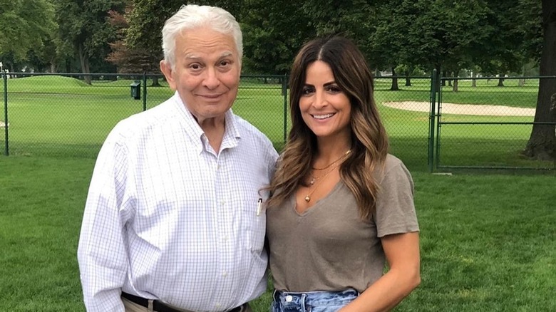 Alison Victoria standing next to her dad