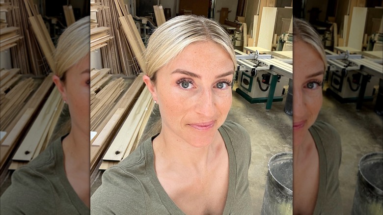 Jasmine Roth taking a selfie in front of construction supply