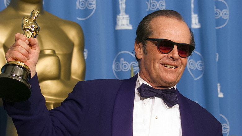 Jack Nicholson in purple suit holding Oscar