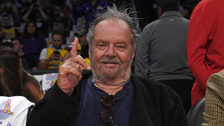 Jack Nicholson with gray hair and raised finger 