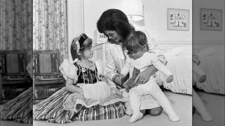 Jackie Kennedy holding her two children