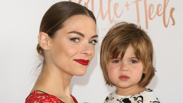 Close up of Jaime King in red and son James Knight