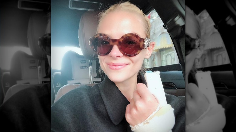 Close of up Jaime King wearing sunglasses with bandaged hand